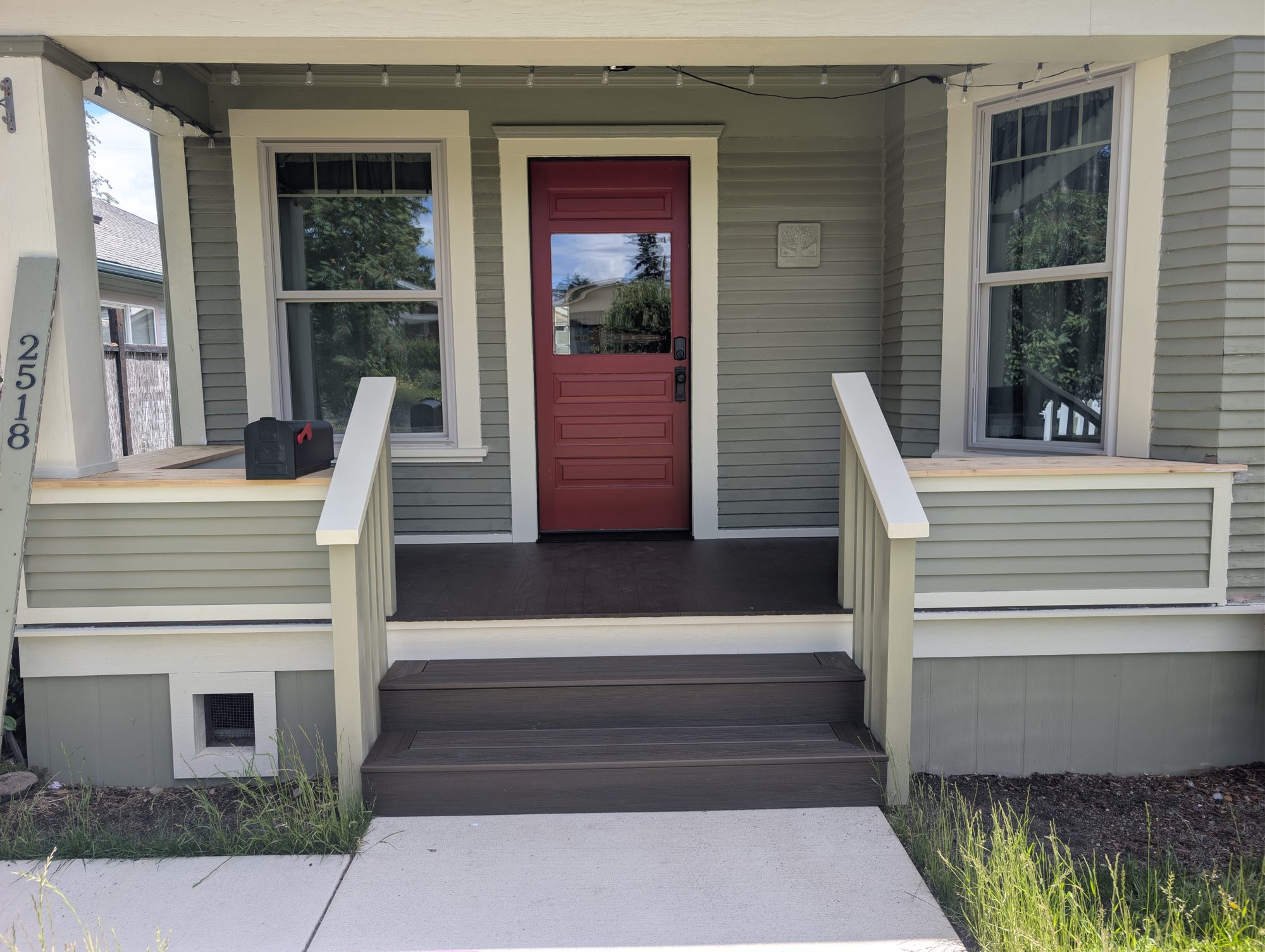 Home exterior with covered porch and red door in Blaine, WA